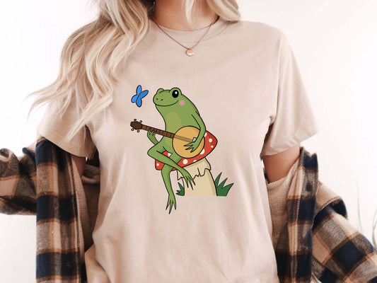 Cottagecore Aesthetic Frog with Banjo T-Shirt – Cute Vintage Nature Tee, Folk Music Lover Gift, Whimsical Woodland Graphic Shirt